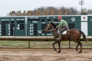 Horse & jockey riding at Fairmount Part Racetrack in Illinois